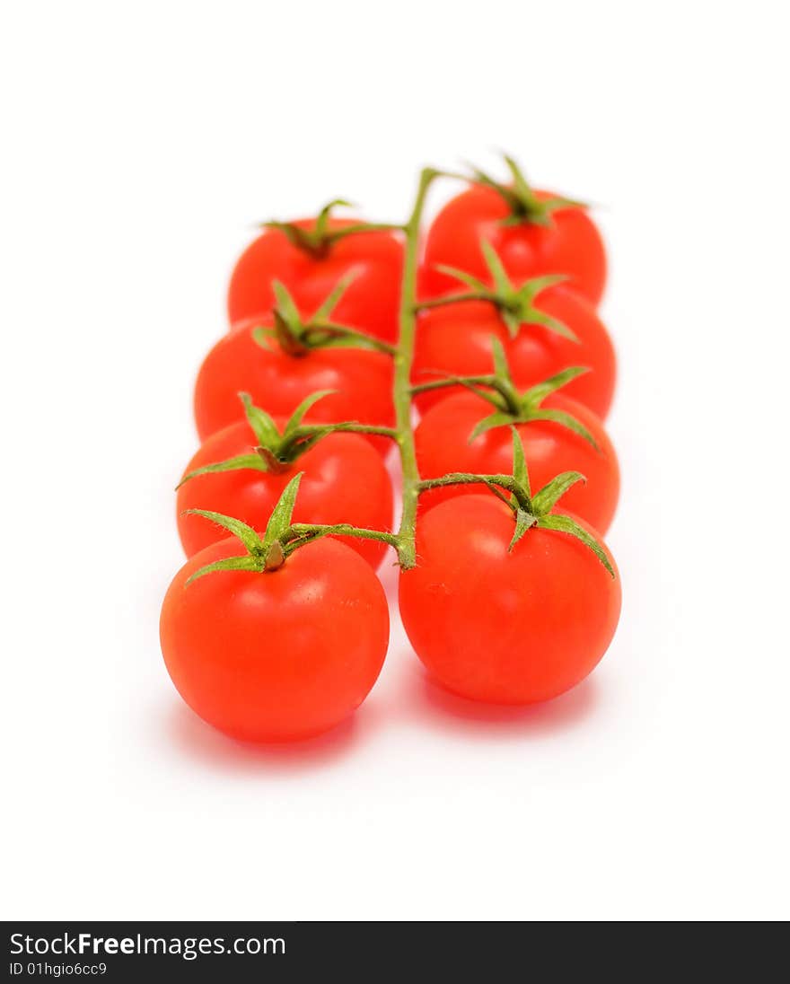 Eight cherry tomatoes on branch