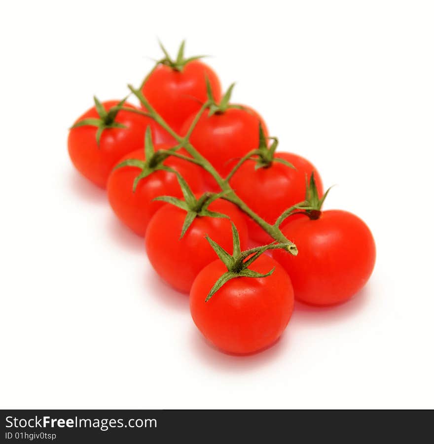 Eight cherry tomatoes on branch