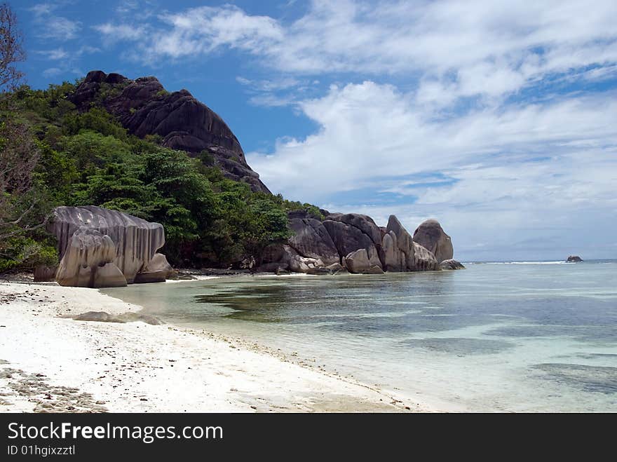 Seychelles stones and palm trees on the bank of azure ocean. Seychelles stones and palm trees on the bank of azure ocean