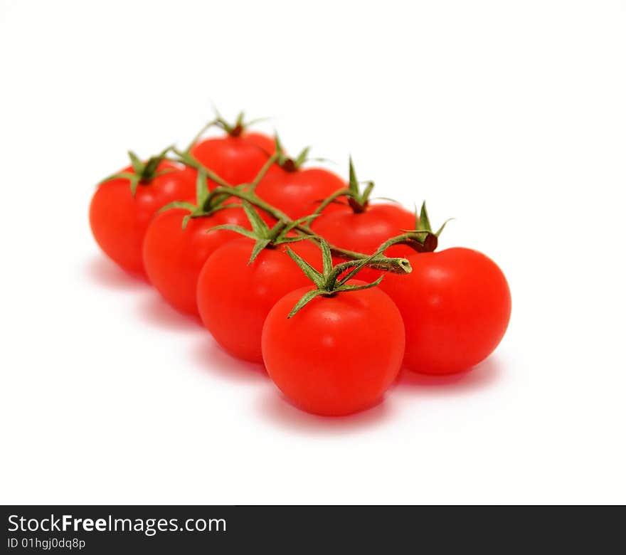 Eight cherry tomatoes on branch