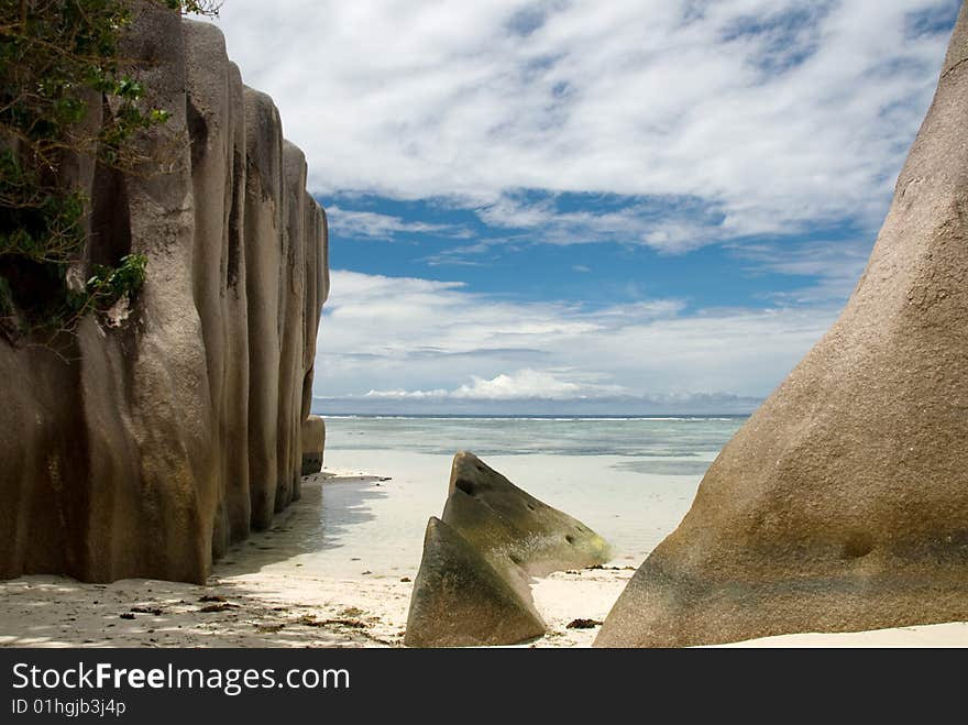 Seychelles stones and palm trees on the bank of azure ocean. Seychelles stones and palm trees on the bank of azure ocean