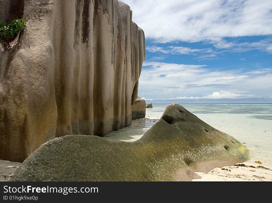 Seychelles stones and palm trees on the bank of azure ocean. Seychelles stones and palm trees on the bank of azure ocean