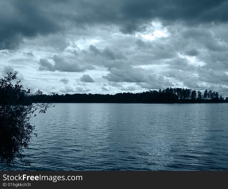 Photo of Dark lake, island, trees