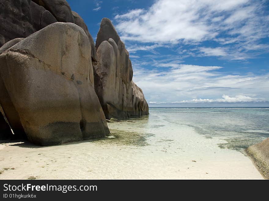 Seychelles stones and palm trees on the bank of azure ocean. Seychelles stones and palm trees on the bank of azure ocean