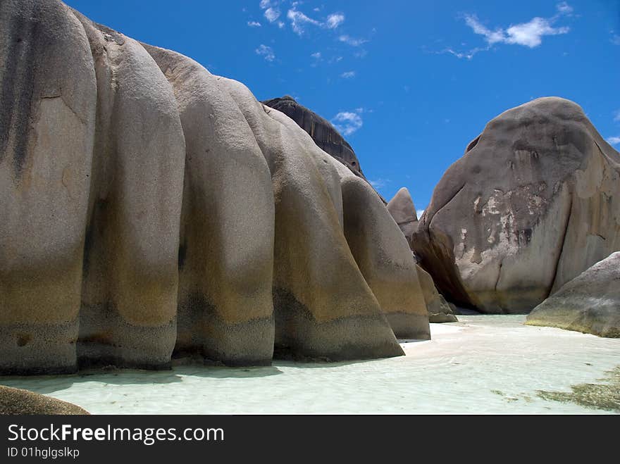 Seychelles stones and palm trees on the bank of azure ocean. Seychelles stones and palm trees on the bank of azure ocean