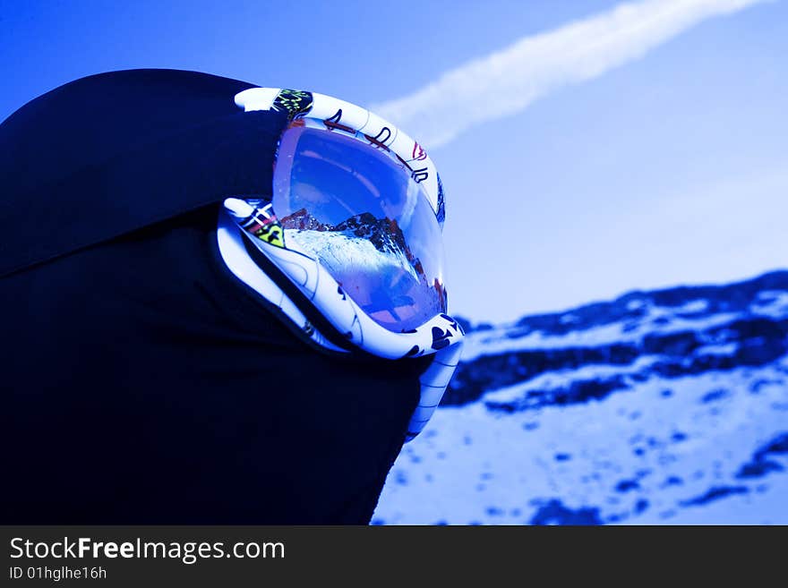 Skier With Mountain Peaks Reflected On Mask