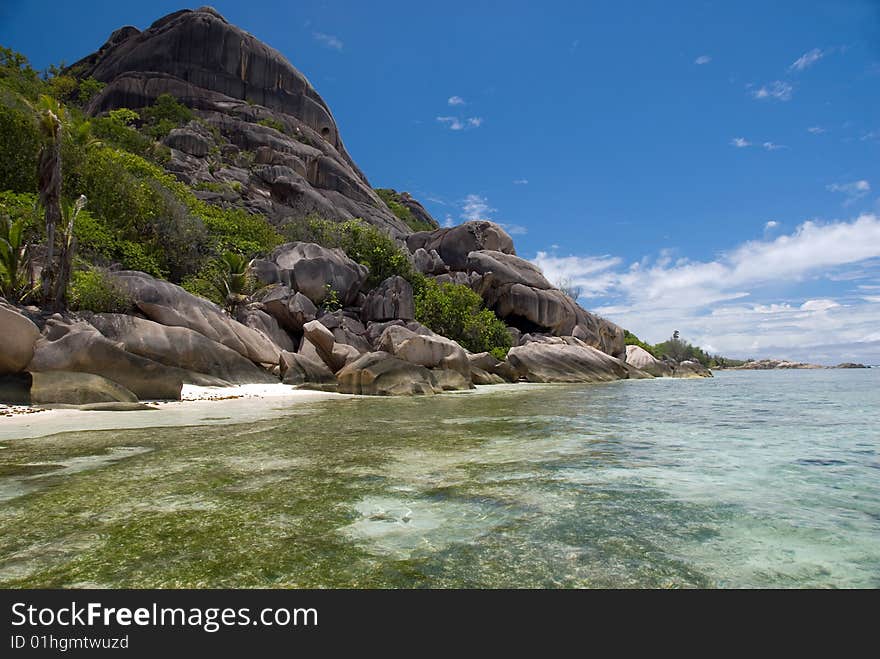 Seychelles stones and palm trees on the bank of azure ocean. Seychelles stones and palm trees on the bank of azure ocean