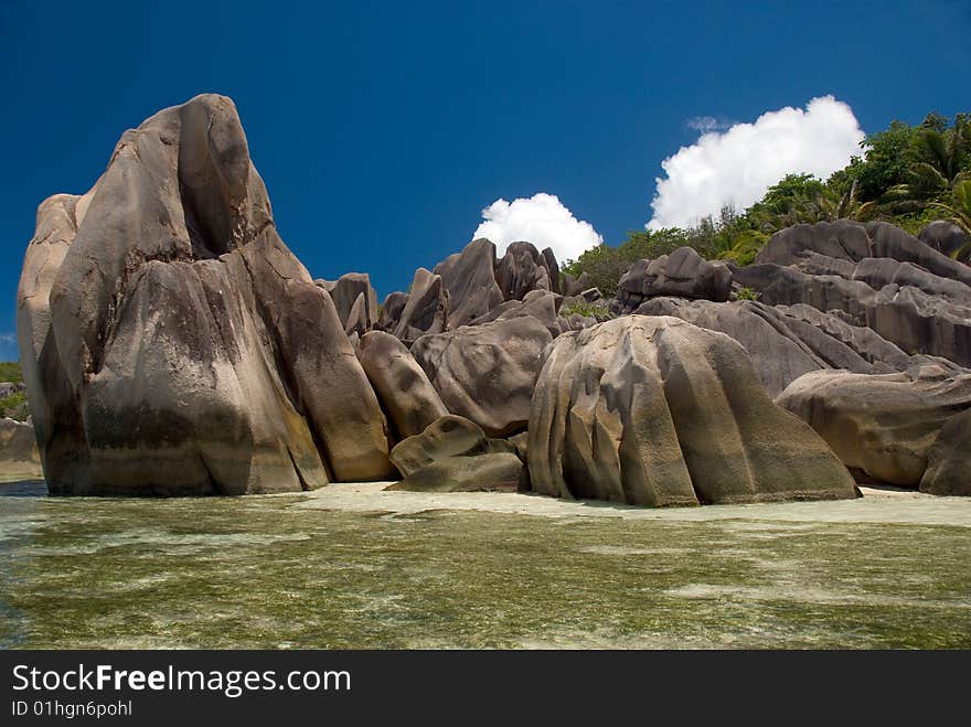 Seychelles stones and palm trees on the bank of azure ocean. Seychelles stones and palm trees on the bank of azure ocean