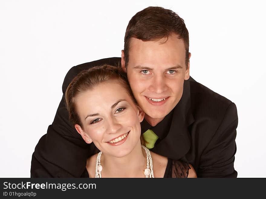 Young couple in formal dress holding each other in love