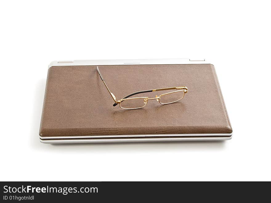 Laptop, note book and glasses isolated on white