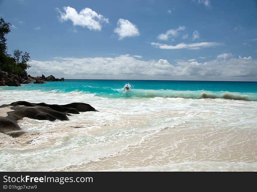 Seychelles stones and palm trees on the bank of azure ocean. Seychelles stones and palm trees on the bank of azure ocean