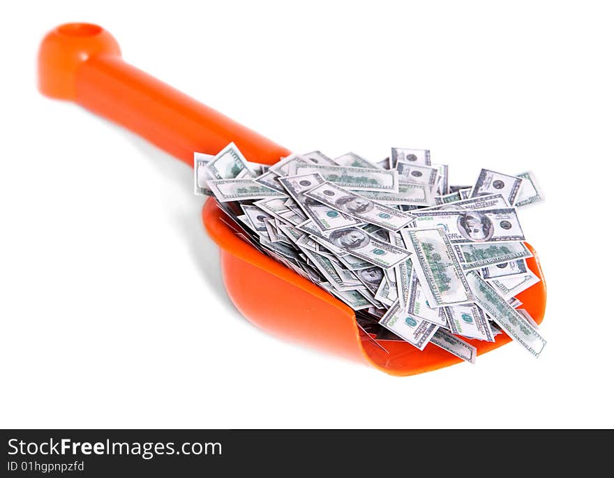 Toy shovel full of dollars isolated on white. Toy shovel full of dollars isolated on white