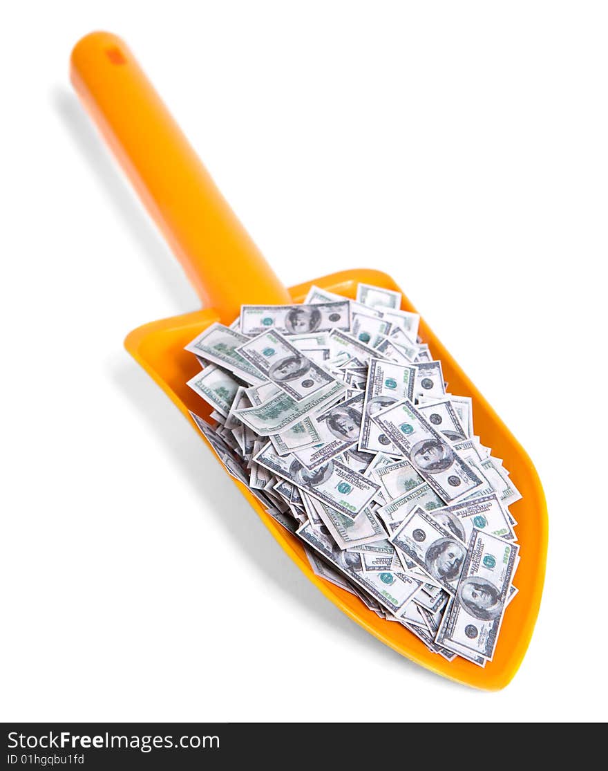 Toy shovel full of dollars isolated on white. Toy shovel full of dollars isolated on white