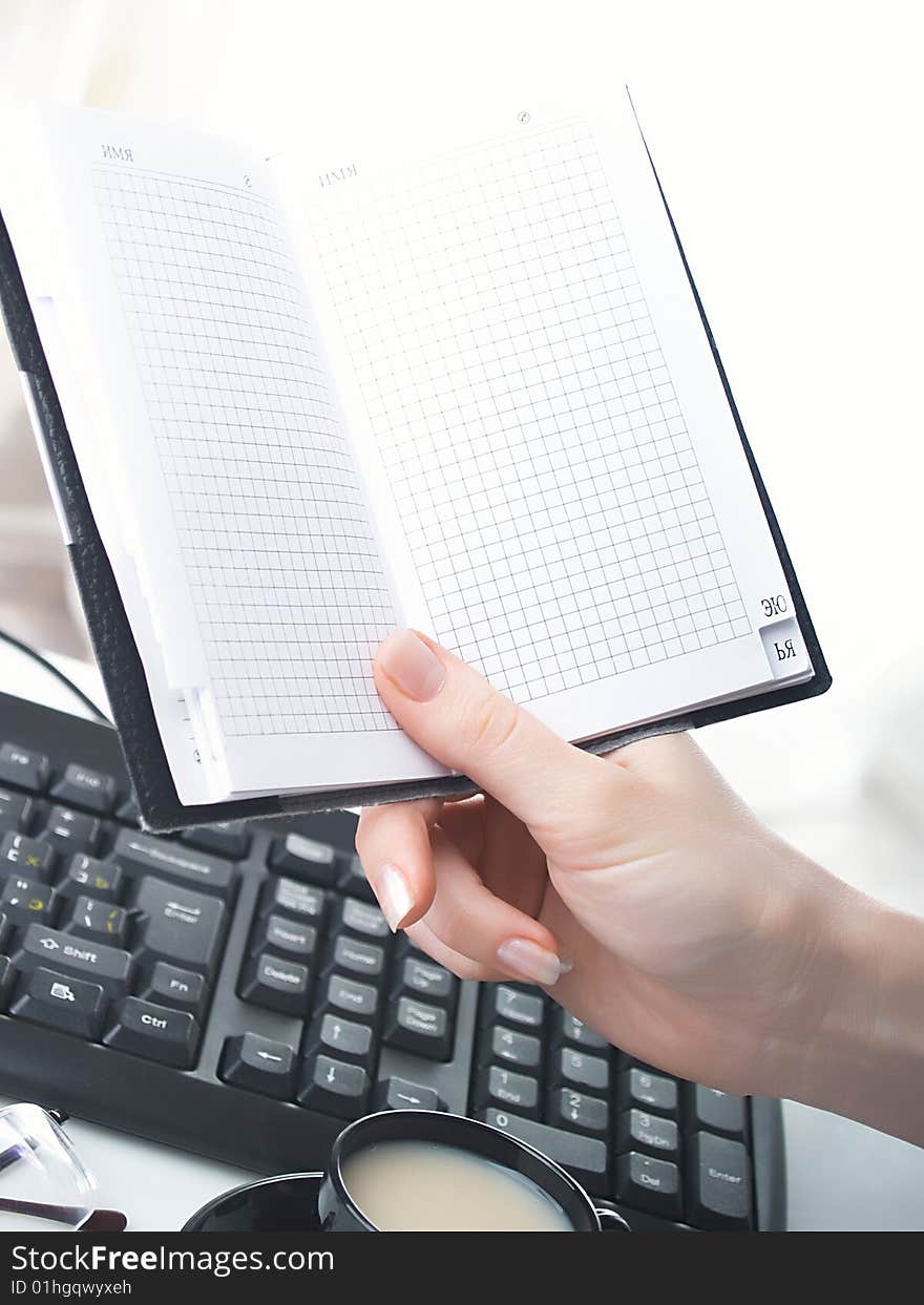 Hand with notebook