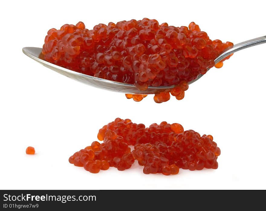 Red caviar on a spoon isolated over white background. Red caviar on a spoon isolated over white background