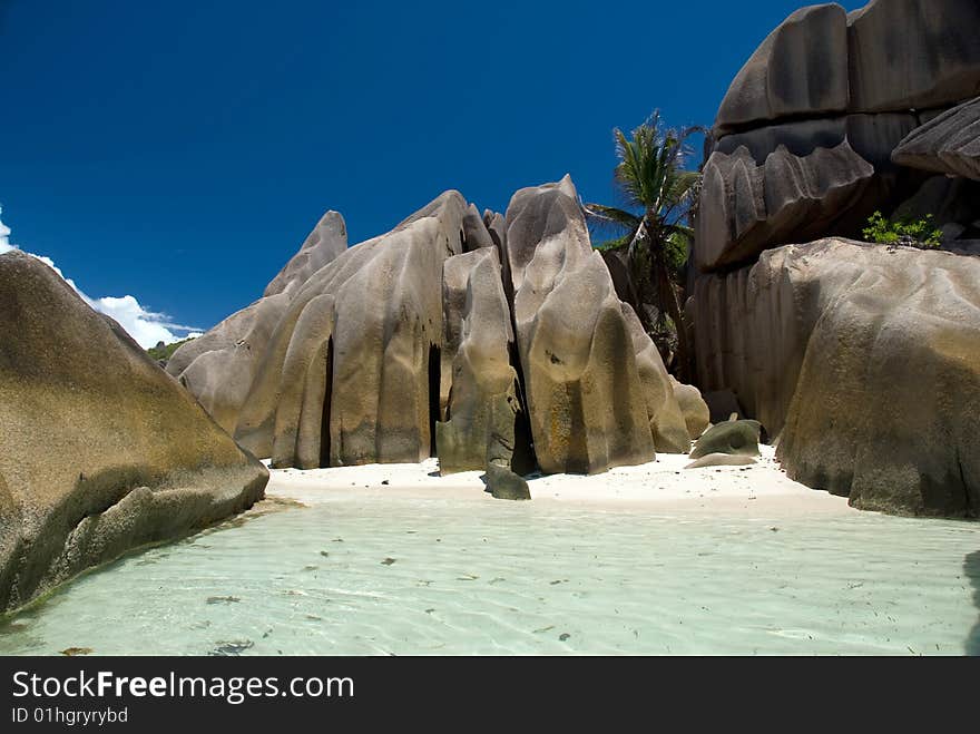 Seychelles stones and palm trees on the bank of azure ocean. Seychelles stones and palm trees on the bank of azure ocean