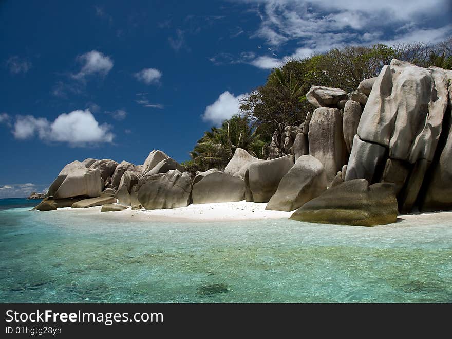 Seychelles stones and palm trees on the bank of azure ocean. Seychelles stones and palm trees on the bank of azure ocean