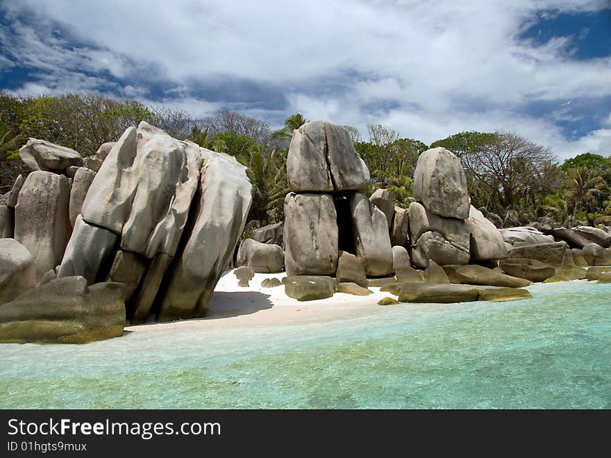 Seychelles stones and palm trees on the bank of azure ocean. Seychelles stones and palm trees on the bank of azure ocean