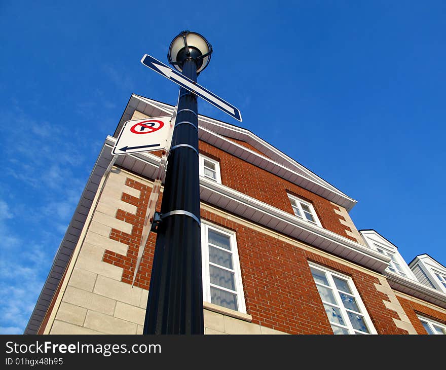 A town home with a light post and a blue sky