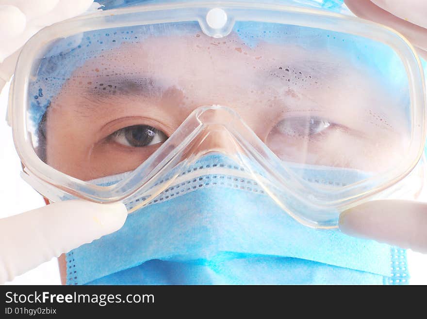 Close-up of doctor with goggles in white background