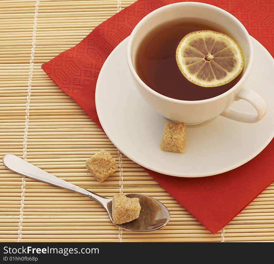 Tea in a white bowl with lemon and sugar