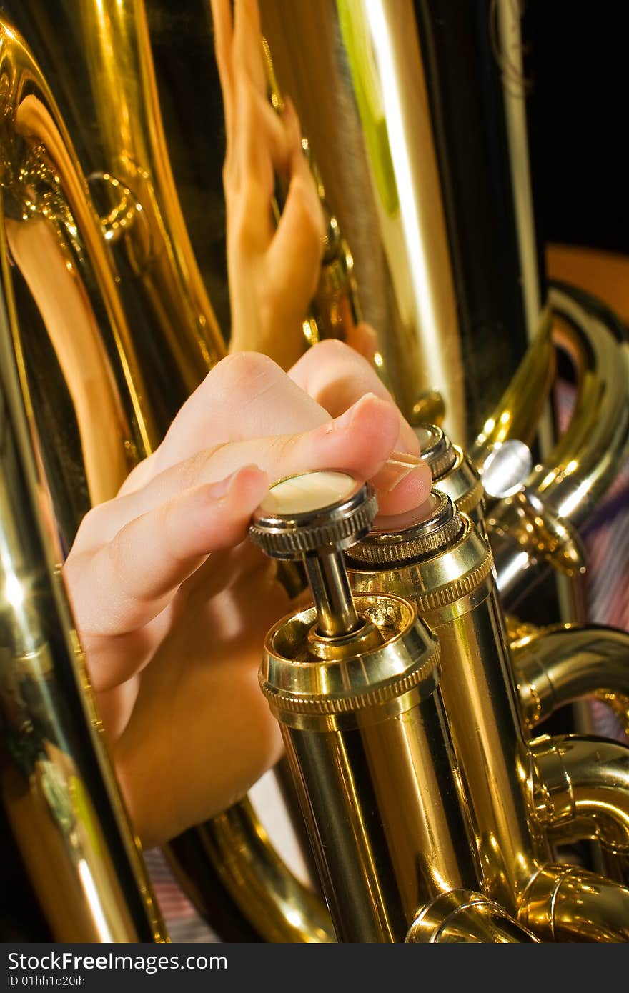 Fingers pushing down the keys of a euphonium. Fingers pushing down the keys of a euphonium