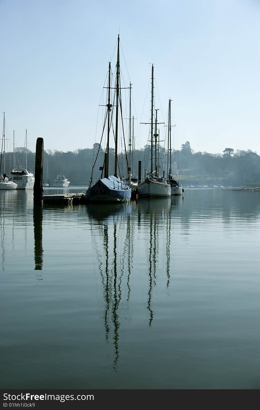 Image of yachts reflected in water. Image of yachts reflected in water