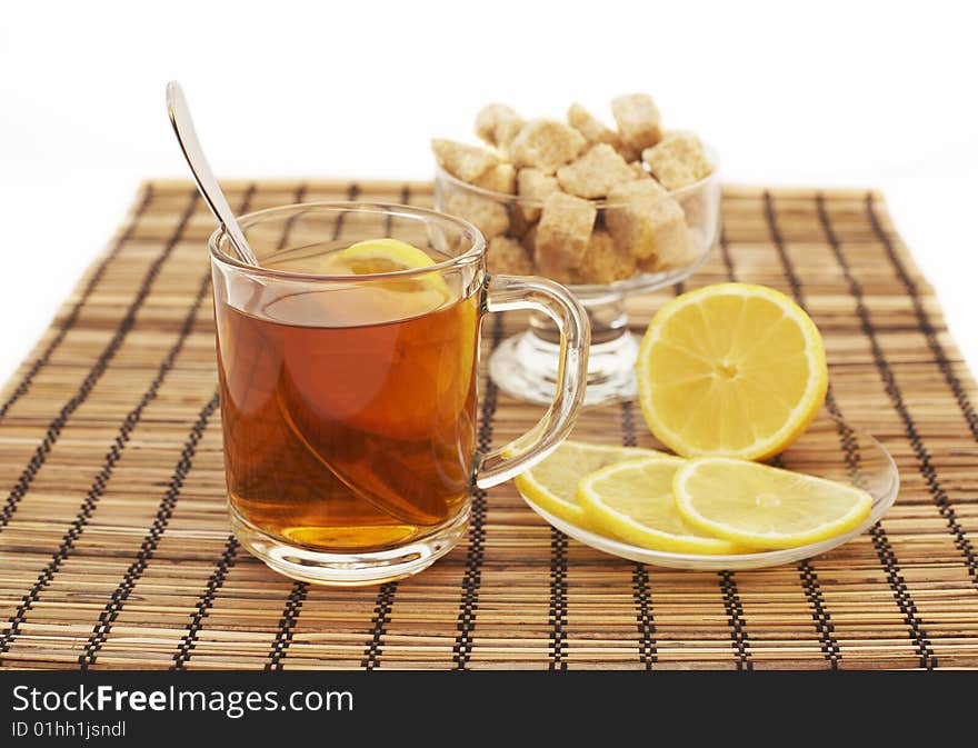 Tea with lemon and sugar on the textile background