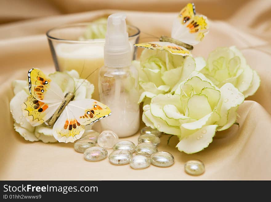 Bath accessories and roses on satin