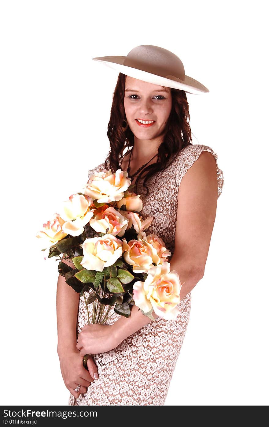 Beautiful lady in a beige dress and hat standing in the studio with yellow 
roses in her arm's smiling, for white background. Beautiful lady in a beige dress and hat standing in the studio with yellow 
roses in her arm's smiling, for white background.