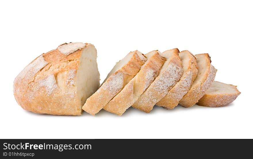 Fresh village bread cut on slices isolated at the white background