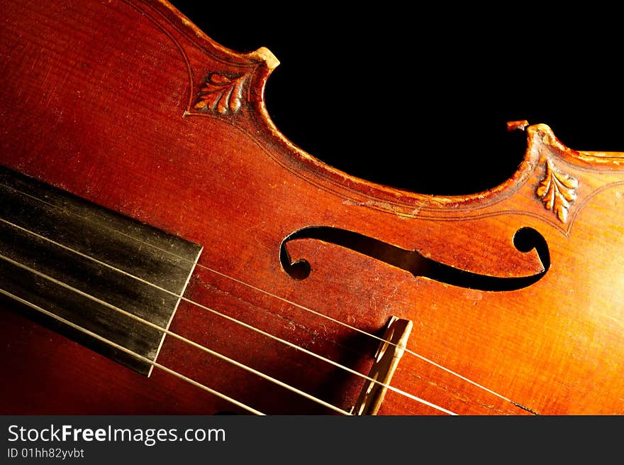 Part of vintage violin on black background