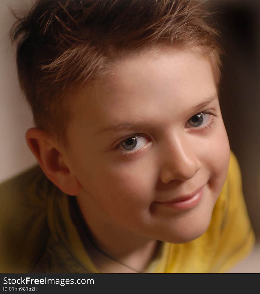 Portrait of a beautiful boy in a yellow T-shirt smiling. Portrait of a beautiful boy in a yellow T-shirt smiling