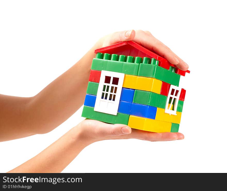 Small house in woman hands isolated on white