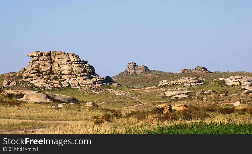 Mountain with rocks under blue sky. Mountain with rocks under blue sky