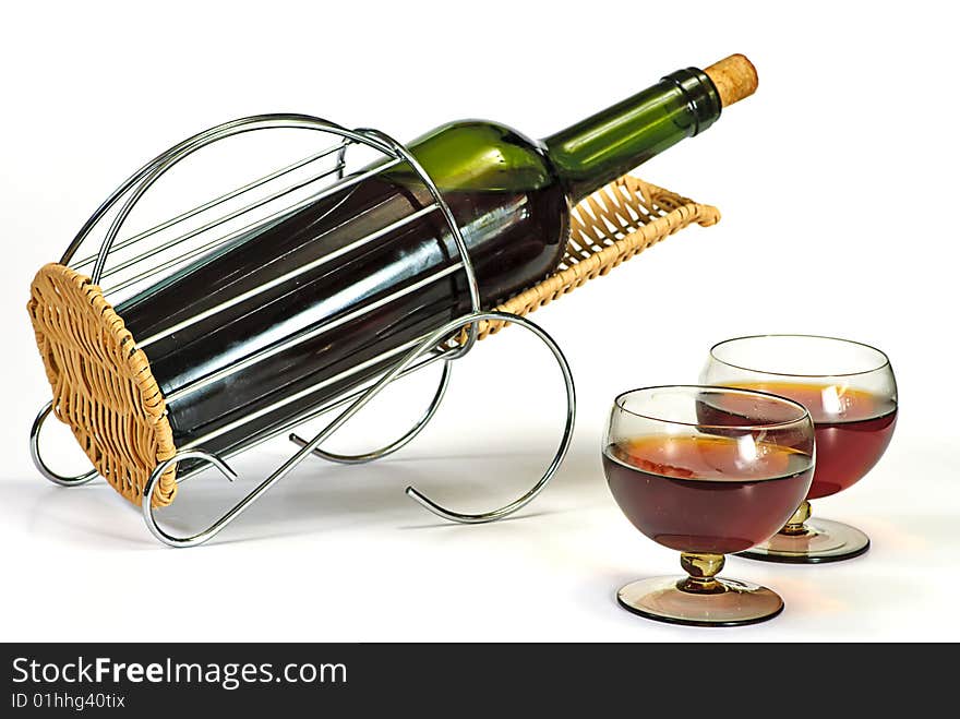 Wine bottle in basket and two glasses