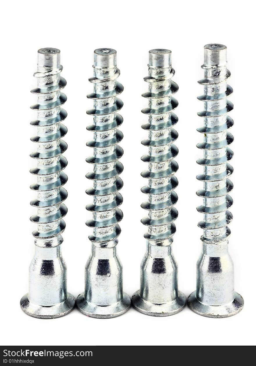 Four steel furniture screws standing vertical