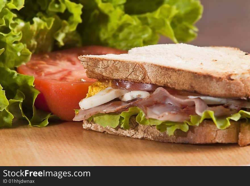 Bacon and egg sandwich on wooden board