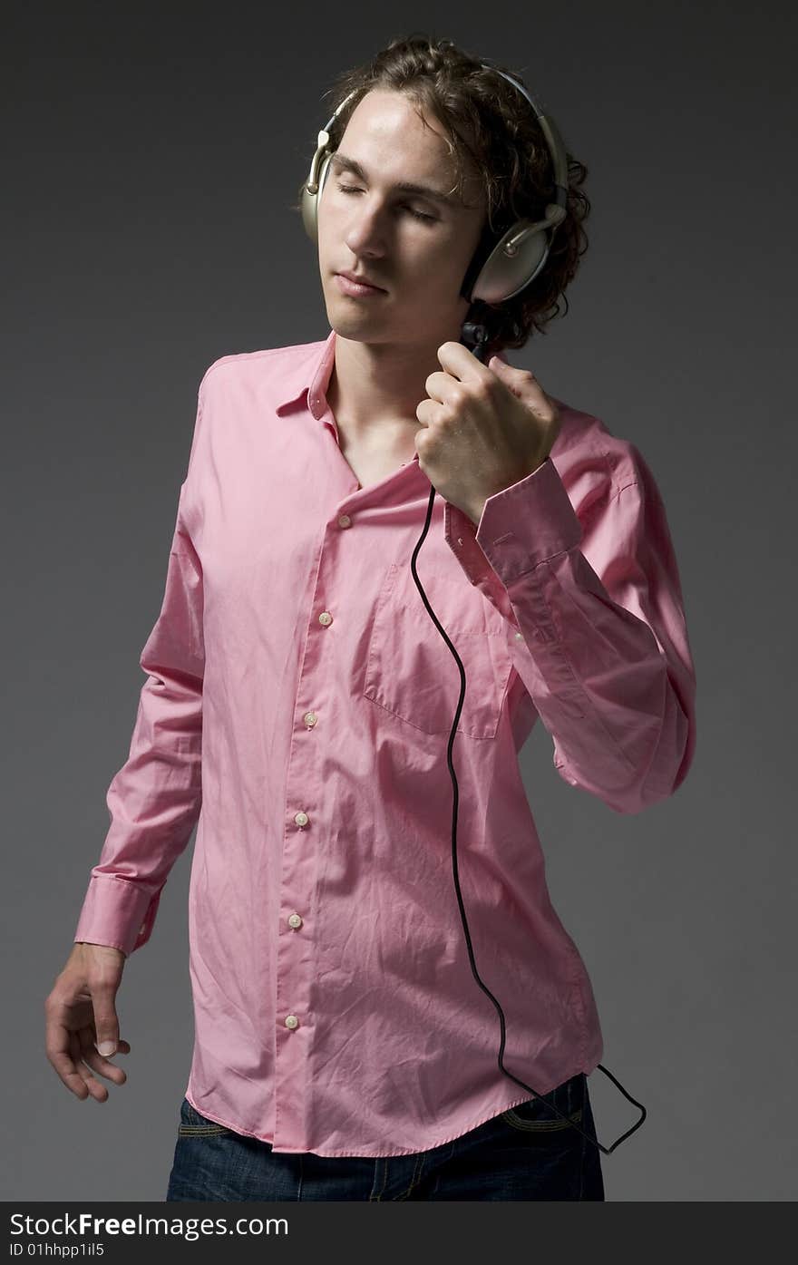 Young man listens on headphones music. Young man listens on headphones music