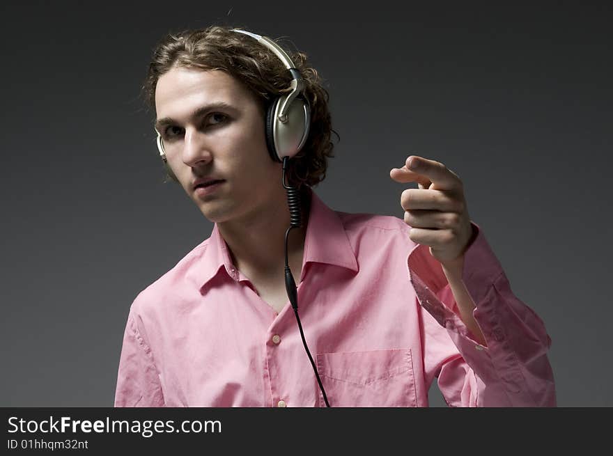 Young man listens on headphones music. Young man listens on headphones music