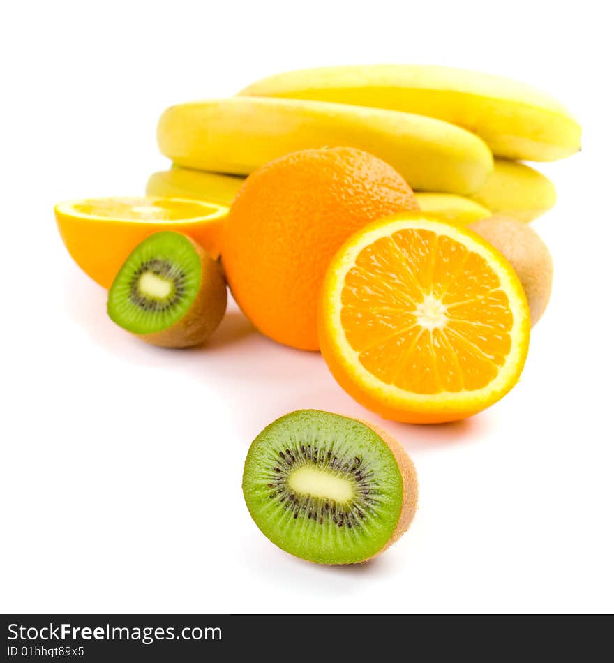 Kiwi, oranges and bananas closeup on white