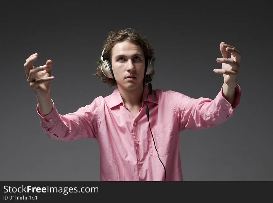 Young man listens on headphones music. Young man listens on headphones music