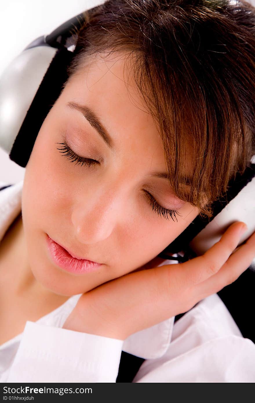 A closeup of businesswoman tuned to music