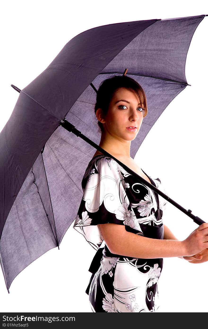 Side pose of young woman holding an umbrella