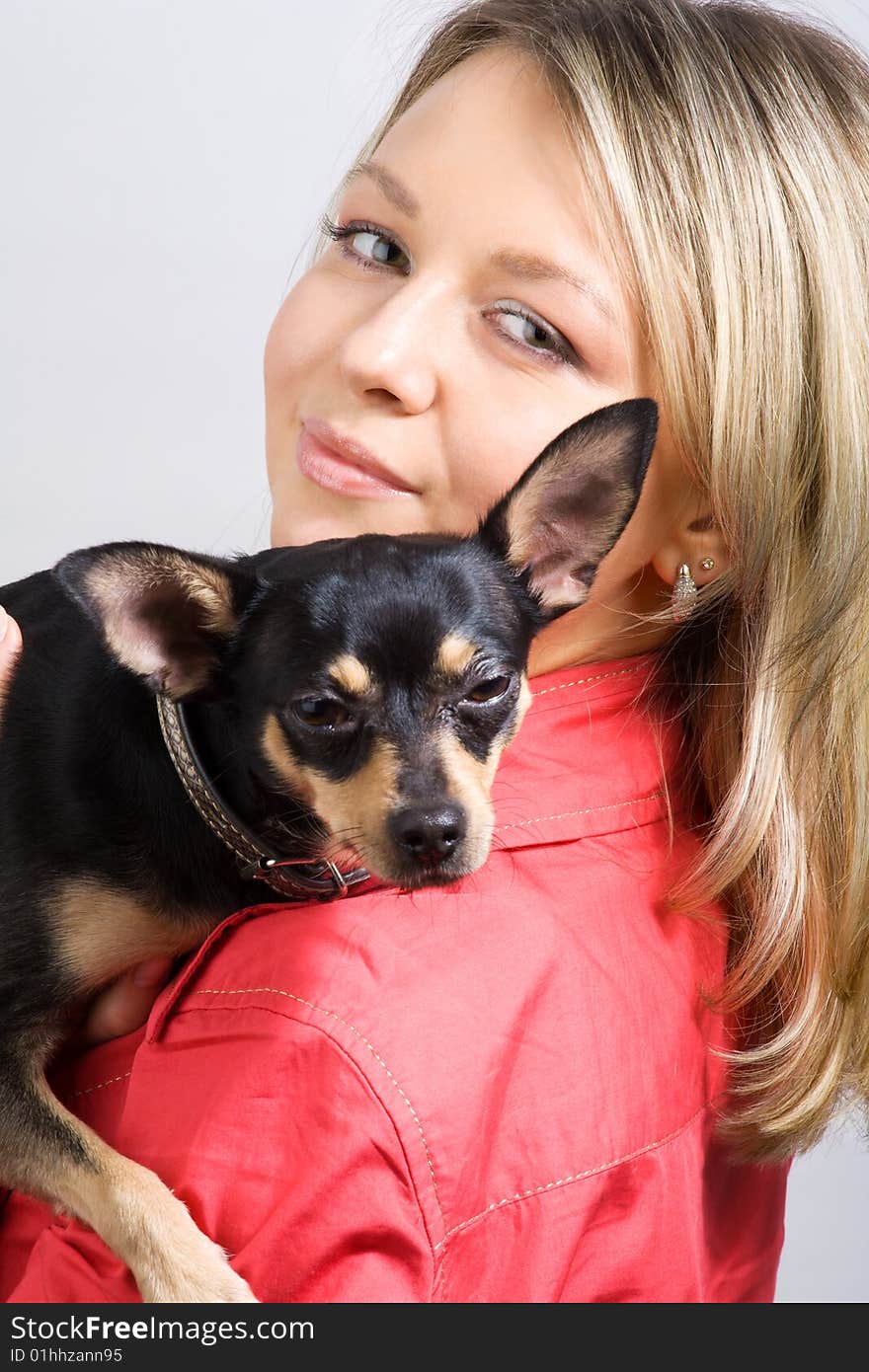 Young woman is embracing small dog (toy-terrier). Young woman is embracing small dog (toy-terrier)