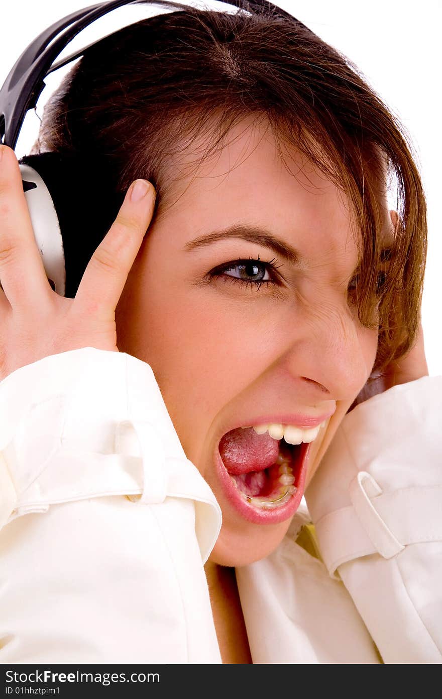 Side pose of screaming woman listening to music with white background