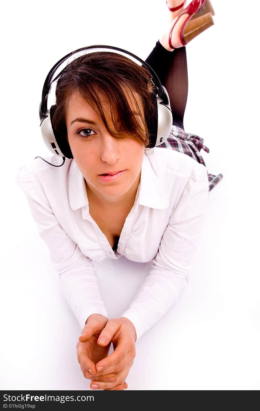 Front view of fashionable female enjoying music on an isolated background