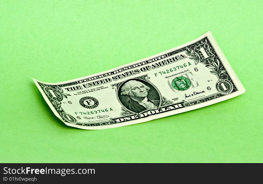 One dollar isolated on green background