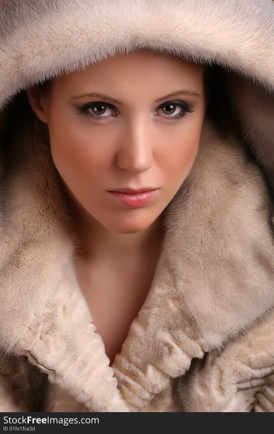 Portrait of attractive young woman wearing fur