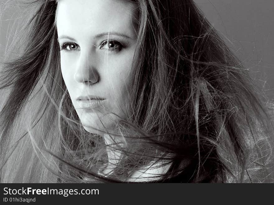 Attractive woman with flowing hair looking away from camera